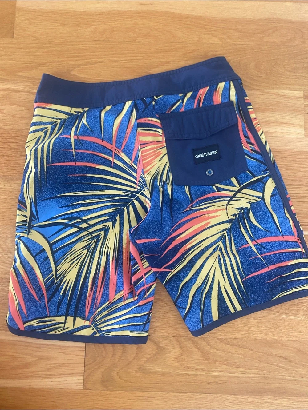 Quiksilver Navy Board Shorts with Yellow & Coral Palm Print. Size 26 or boys 12